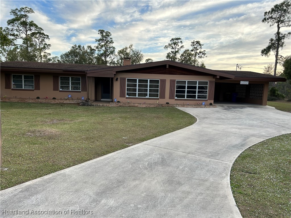 3505 Golfview Road Sebring, FL 33875 - Photo 1 of 50 a view of a yard in front of a house with a yard