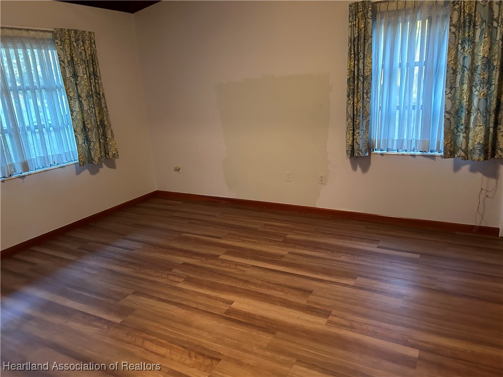 3505 Golfview Road Sebring, FL 33875 - Photo 29 of 50 an empty room with wooden floor and windows