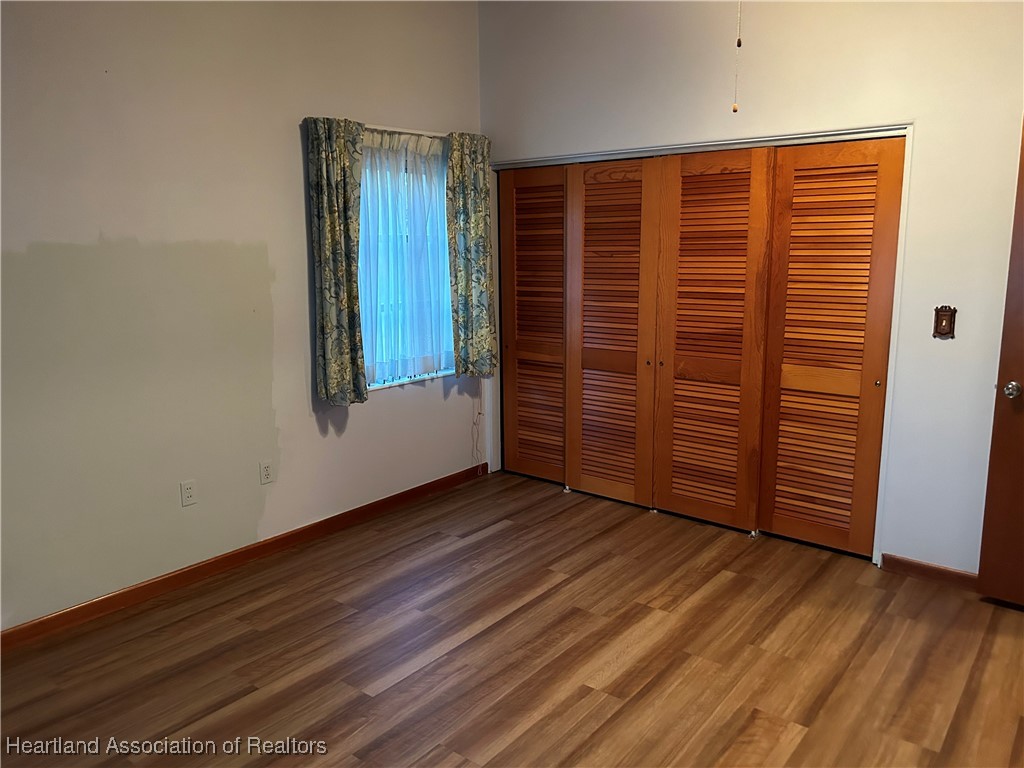 3505 Golfview Road Sebring, FL 33875 - Photo 30 of 50 an empty room with wooden floor and windows