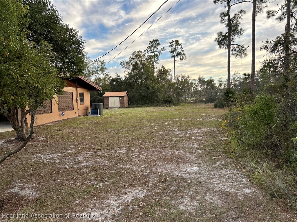 3505 Golfview Road Sebring, FL 33875 - Photo 39 of 50 a view of a house with backyard and trees