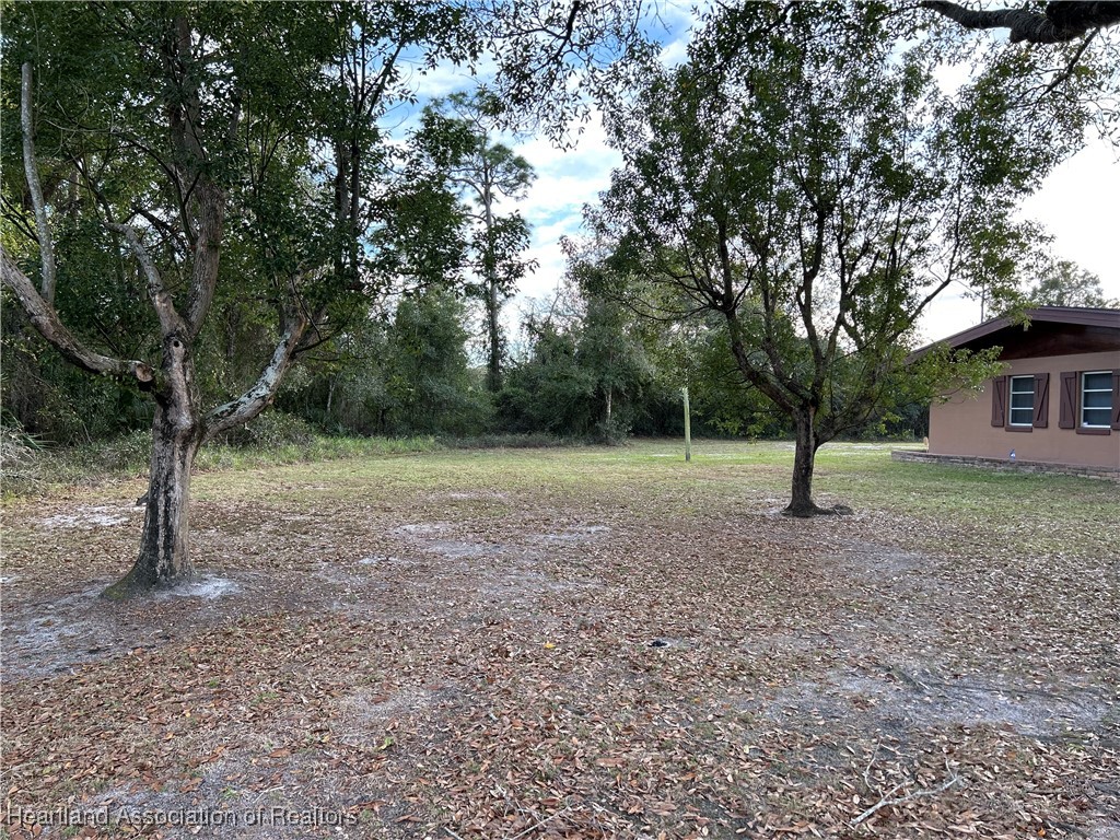 3505 Golfview Road Sebring, FL 33875 - Photo 40 of 50 a view of a outdoor space with deck and trees