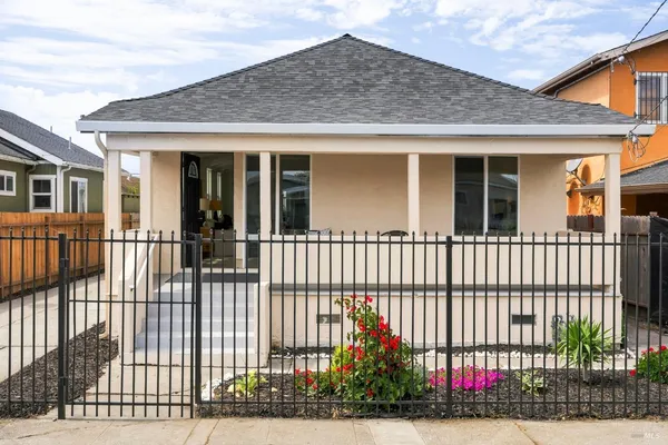 a front view of a house with a garden
