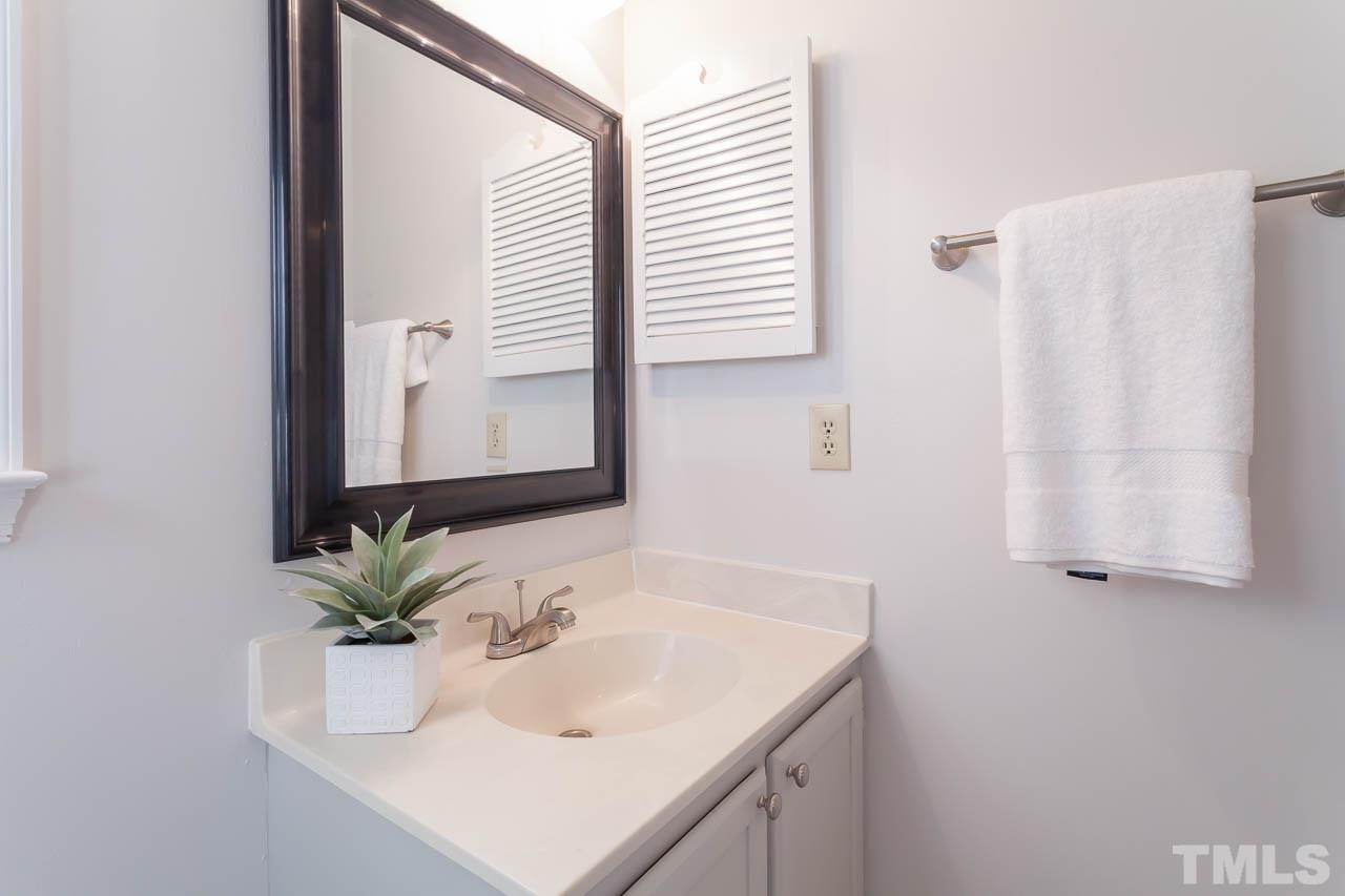 11916 North Exeter Way Raleigh, NC 27613 - Photo 22 of 25 a bathroom with a sink and a mirror