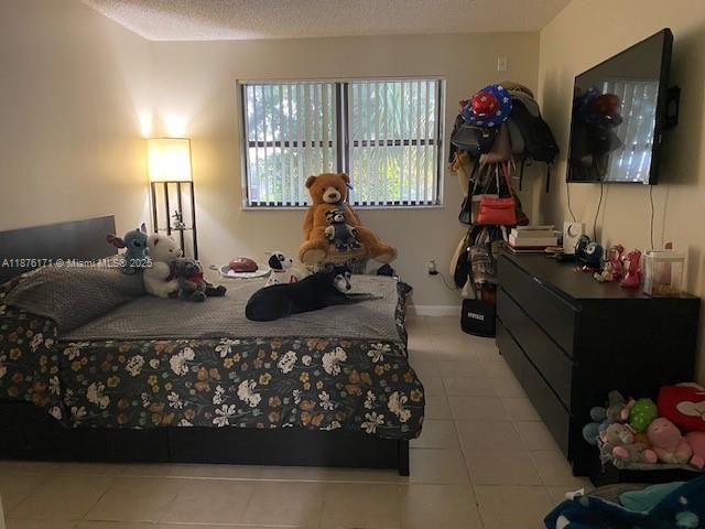 7070 Northwest 179th Street, Unit 201 Hialeah, FL 33015 - Photo 2 of 4 a bed room with two bed and a window