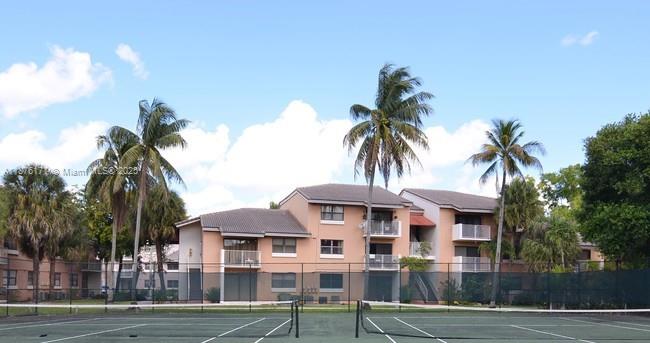 7070 Northwest 179th Street, Unit 201 Hialeah, FL 33015 - Photo 4 of 4 a front view of a house with a garden
