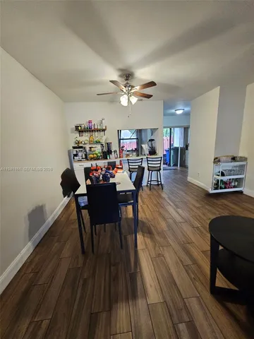 a dining room with furniture and wooden floor