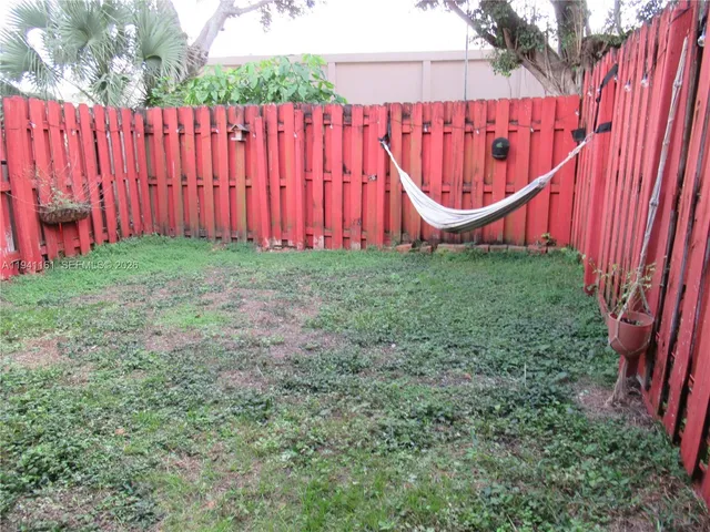 a view of a backyard with a wooden fence