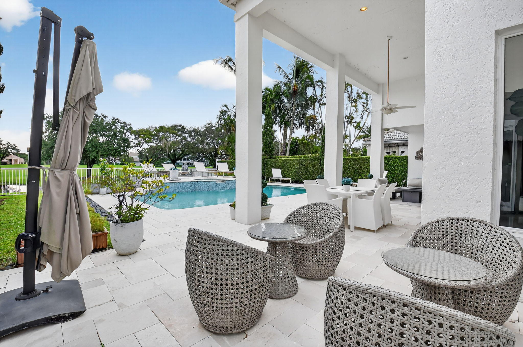 2563 Northwest 63rd Street Boca Raton, FL 33496 - Photo 42 of 65 a patio view with patio furniture and a floor to ceiling window