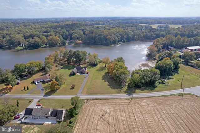 an aerial view of a house with garden space and lake view
