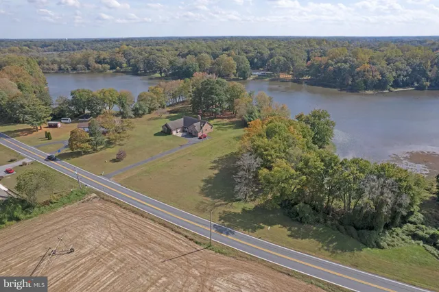 an aerial view of lake residential house with outdoor space and trees around
