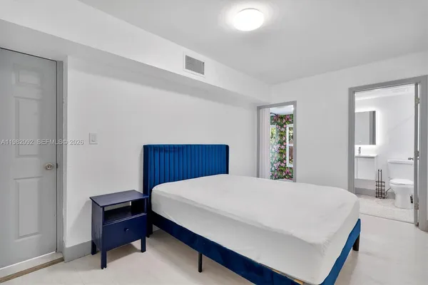 a bedroom with a bed and dresser