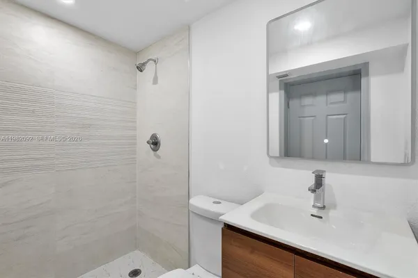 a bathroom with a sink a mirror and shower