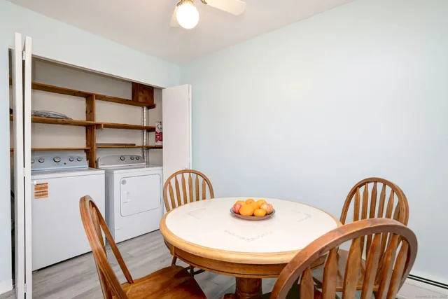 a view of a dining room with furniture and wooden floor