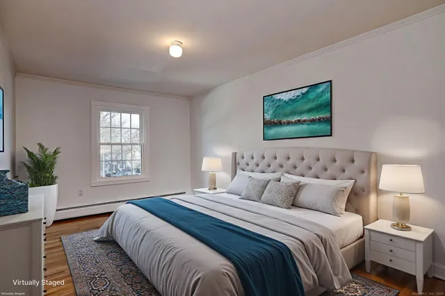 a bedroom with a large bed and a window