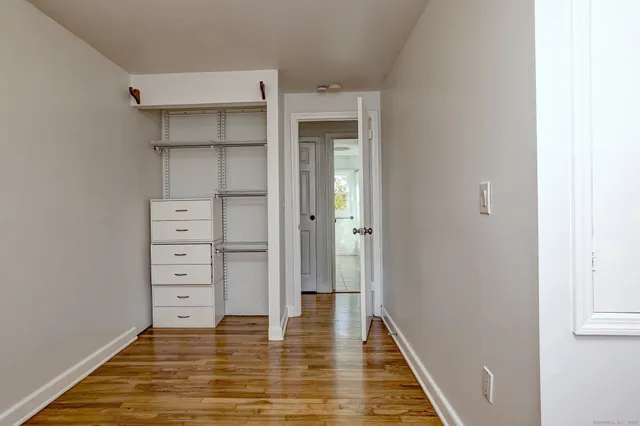a view of walk in closet with empty racks