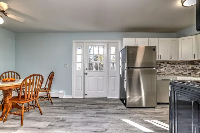 a kitchen with stainless steel appliances granite countertop a refrigerator and a stove top oven