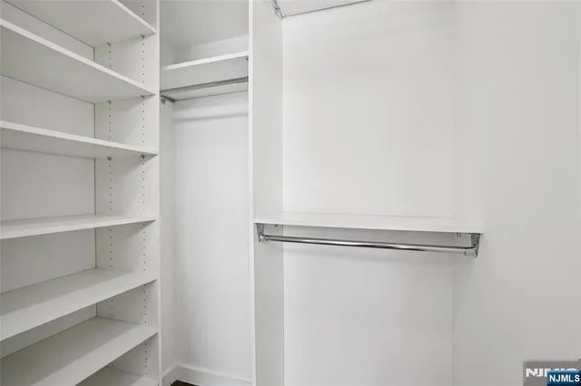 an empty room with wooden floor and white walls