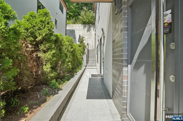 a view of empty room with wooden floor and fireplace