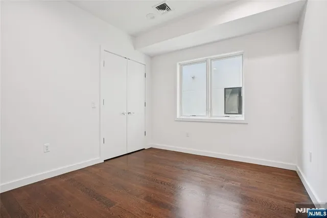 a bathroom with a sink and mirror with toilet