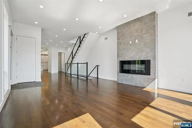 a view of a kitchen with wooden floor and outdoor space