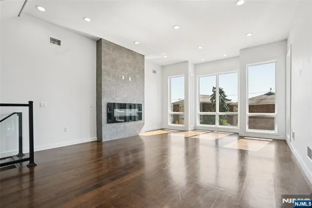 a kitchen with stainless steel appliances a refrigerator and wooden floor