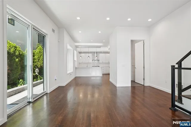 a kitchen with a sink center island a counter space and a window