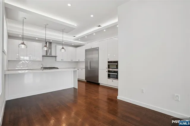 a kitchen with kitchen island a sink stainless steel appliances and cabinets