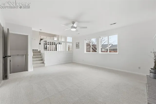 an empty room with windows and entrance