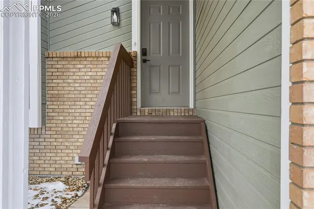 a view of staircase with white walls and windows