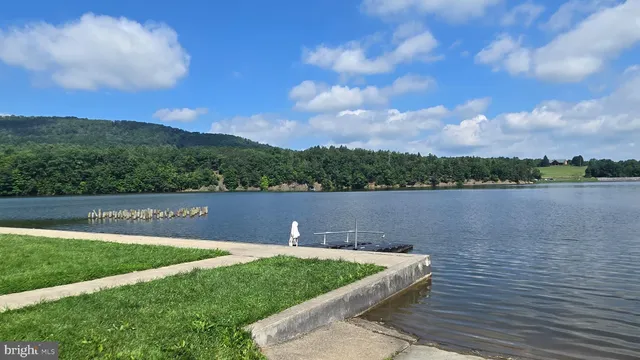 a view of a lake with houses in the back