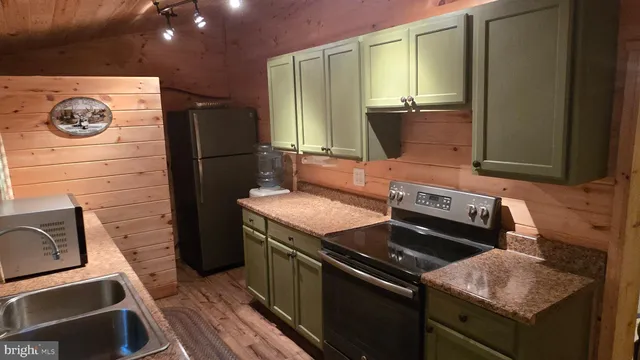 a kitchen with stainless steel appliances granite countertop a stove and a refrigerator