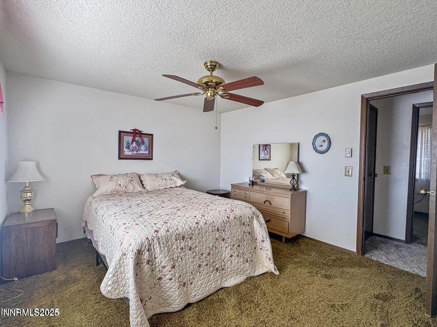 40 Basque Road Orovada, NV 89425 - Photo 11 of 16 a bedroom with a bed and a chandelier