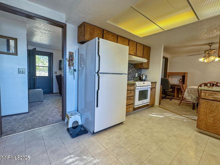40 Basque Road Orovada, NV 89425 - Photo 8 of 16 a kitchen with stainless steel appliances granite countertop a refrigerator and a stove