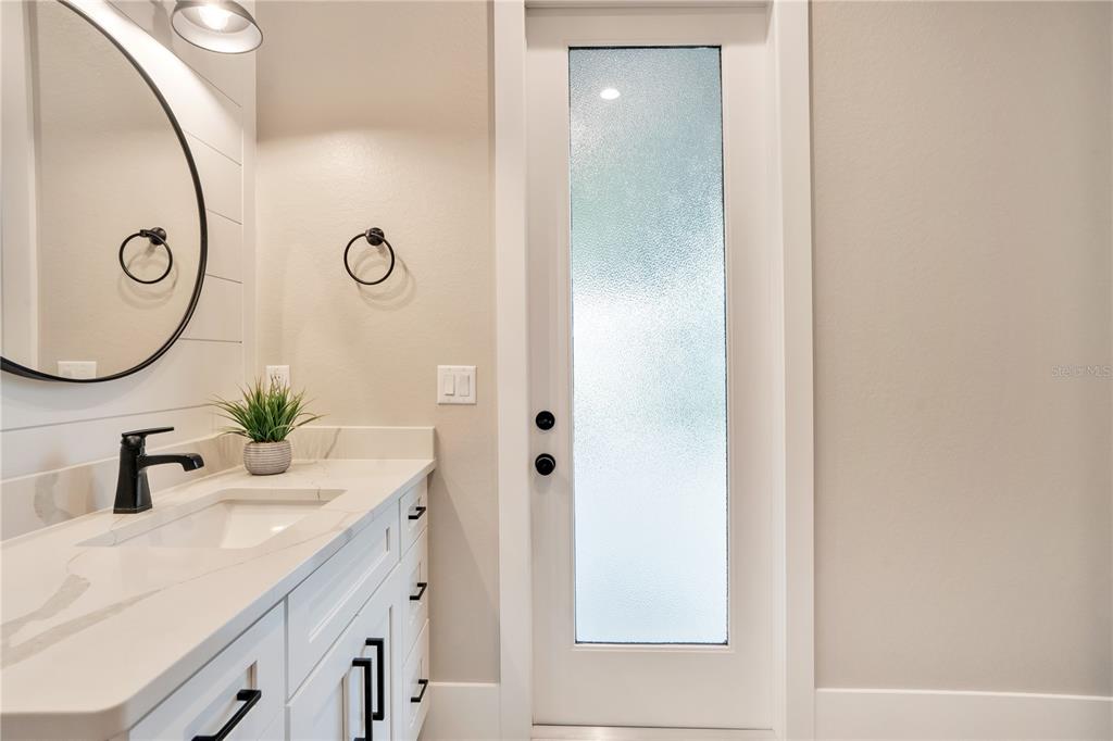 440 Palma Ceia Road Winter Haven, FL 33884 - Photo 40 of 78 a bathroom with a double vanity sink and a mirror