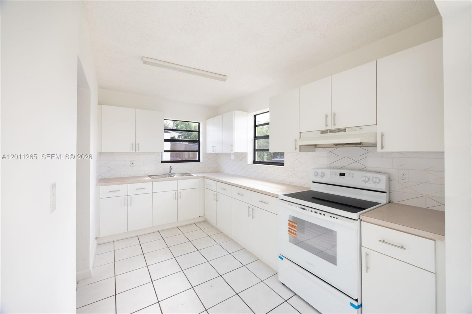 29935 Southwest 143rd Court Homestead, FL 33033 - Photo 11 of 25 a kitchen with cabinets appliances and a sink