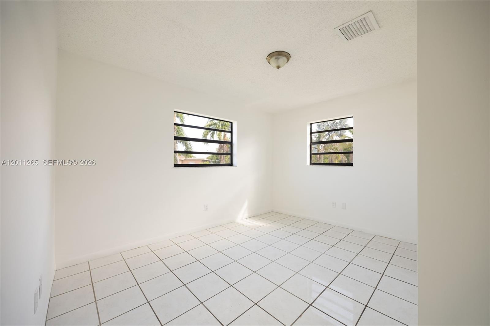 29935 Southwest 143rd Court Homestead, FL 33033 - Photo 12 of 25 a view of a bedroom with window
