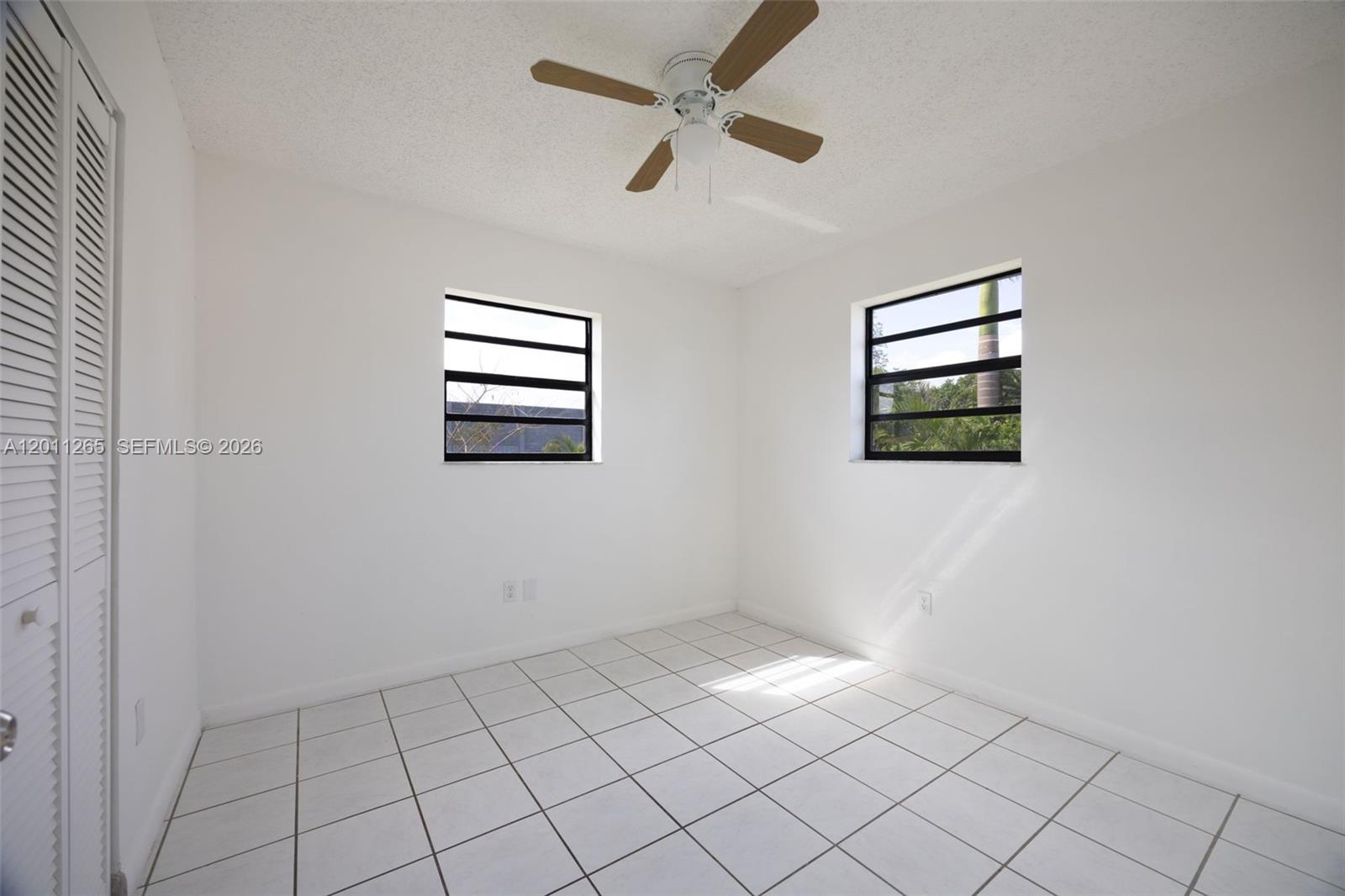 29935 Southwest 143rd Court Homestead, FL 33033 - Photo 16 of 25 wooden floor in an empty room with a window