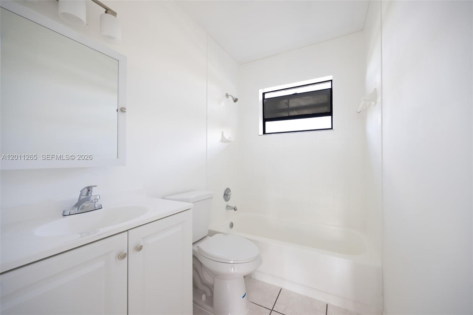 29935 Southwest 143rd Court Homestead, FL 33033 - Photo 18 of 25 a bathroom with a toilet a sink and mirror