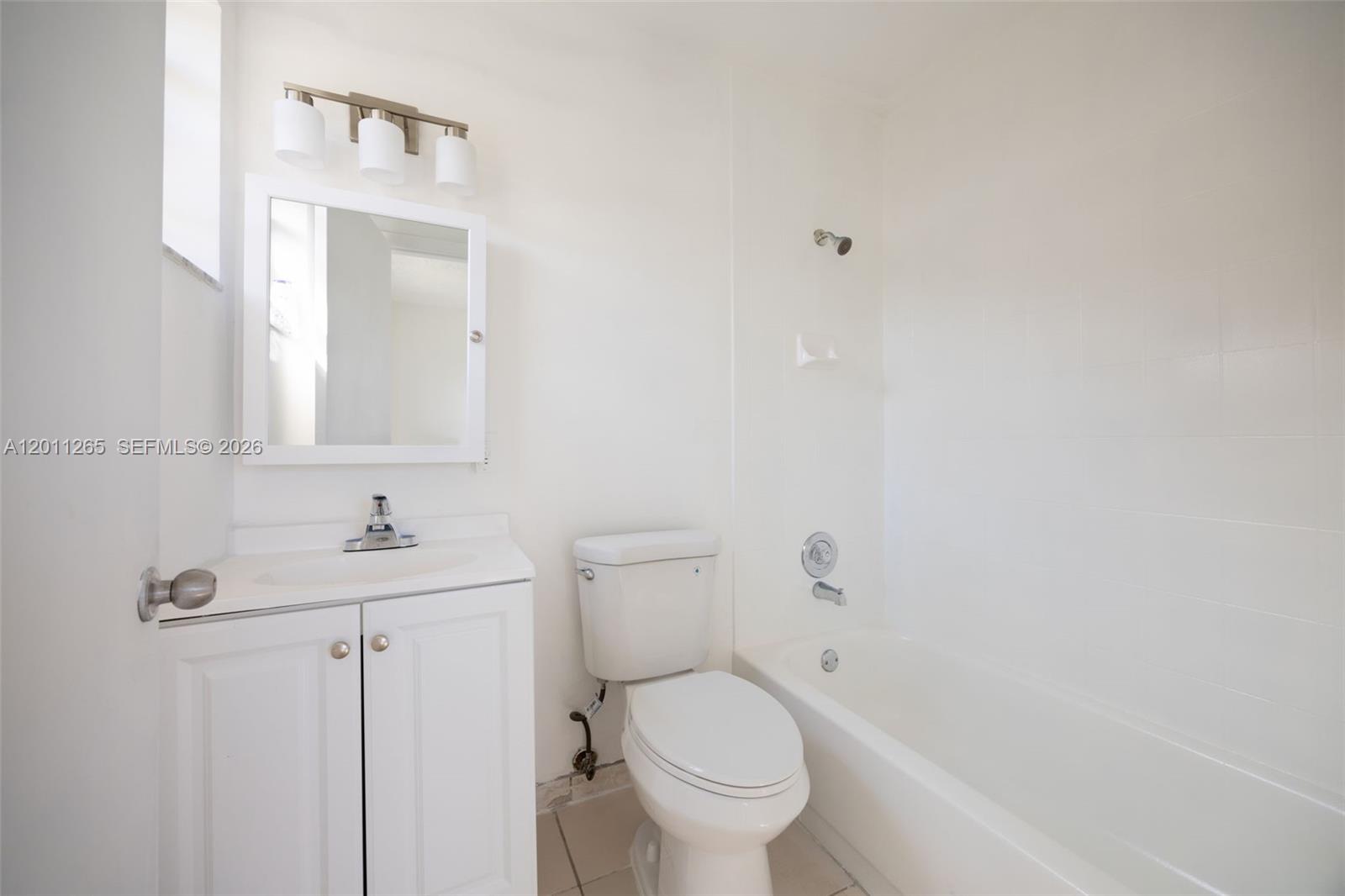 29935 Southwest 143rd Court Homestead, FL 33033 - Photo 19 of 25 a bathroom with a toilet a sink and mirror