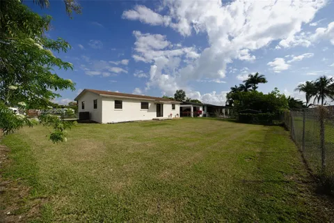 a front view of a house with a garden and yard