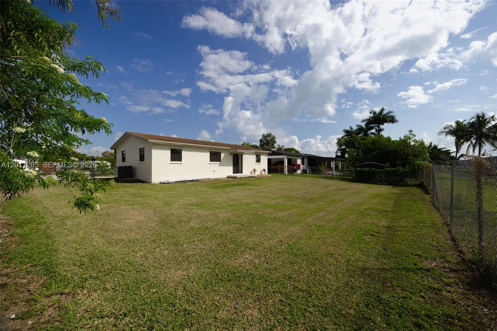 29935 Southwest 143rd Court Homestead, FL 33033 - Photo 20 of 25 a backyard of a house with lots of green space