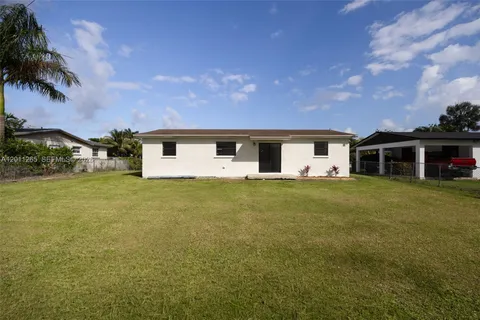 a front view of house with yard and trees