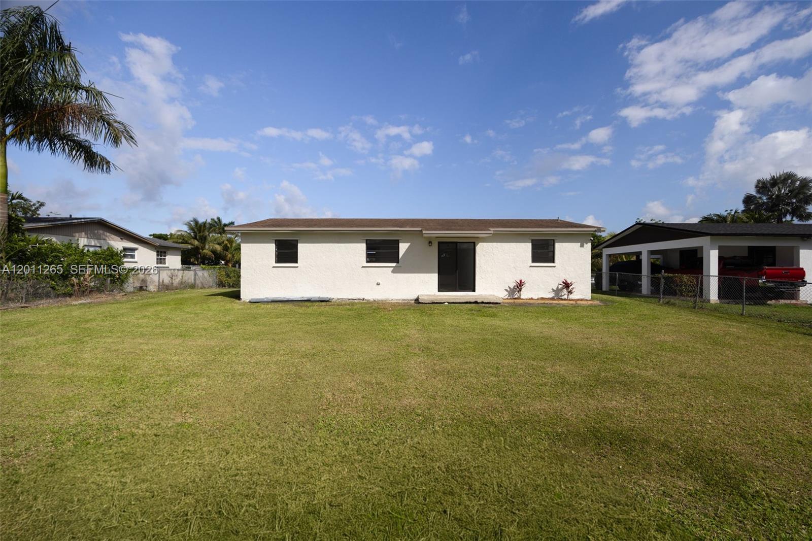 29935 Southwest 143rd Court Homestead, FL 33033 - Photo 21 of 25 a front view of a house with a garden and yard