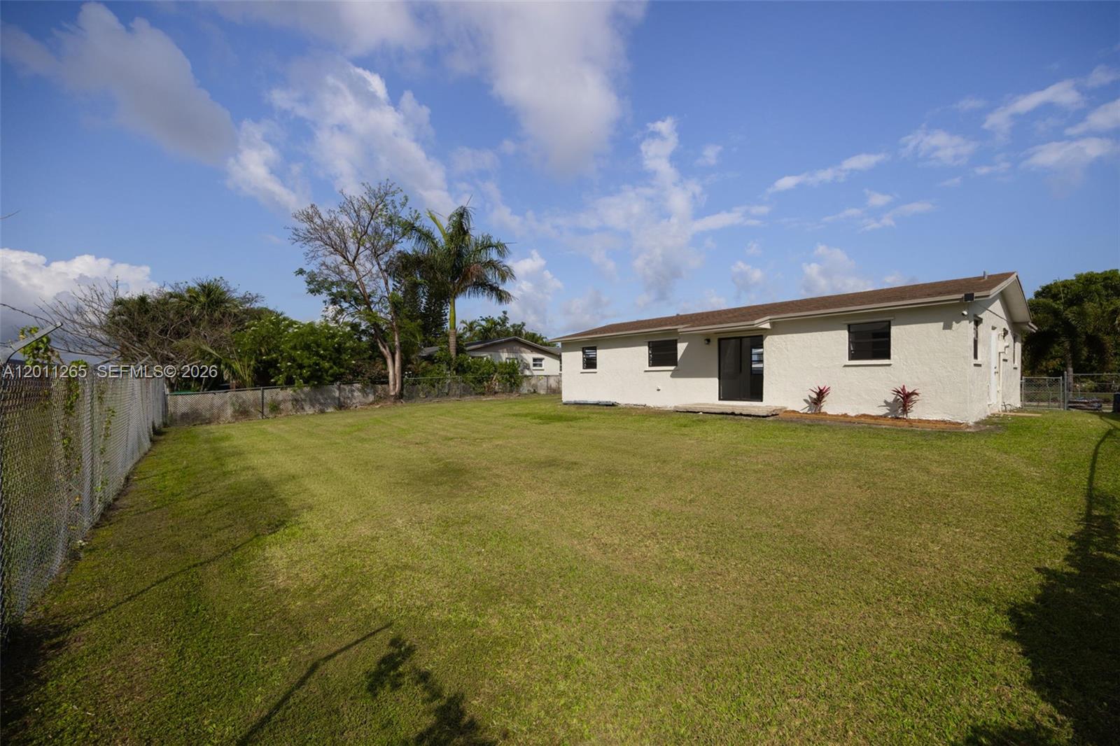 29935 Southwest 143rd Court Homestead, FL 33033 - Photo 22 of 25 a front view of house with yard and trees