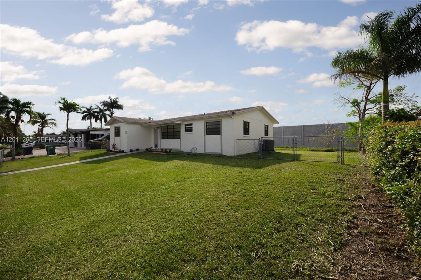 29935 Southwest 143rd Court Homestead, FL 33033 - Photo 3 of 25 a view of a house with a backyard
