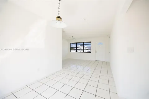 a view of a storage & utility room with refrigerator and toys