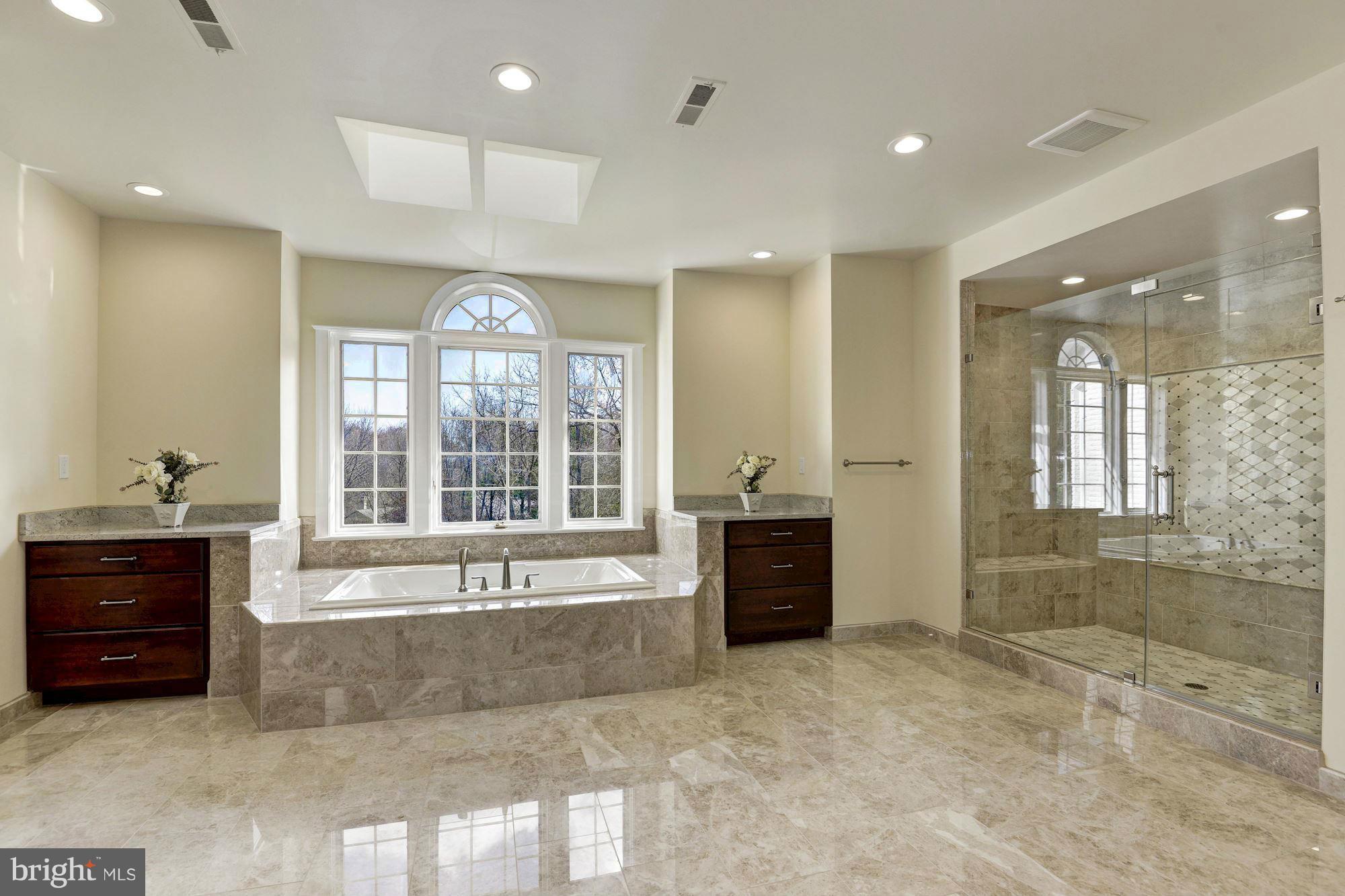 11112 Potomac View Drive Potomac, MD 20854 - Photo 18 of 30 a large spacious bathroom with a large tub shower and sink