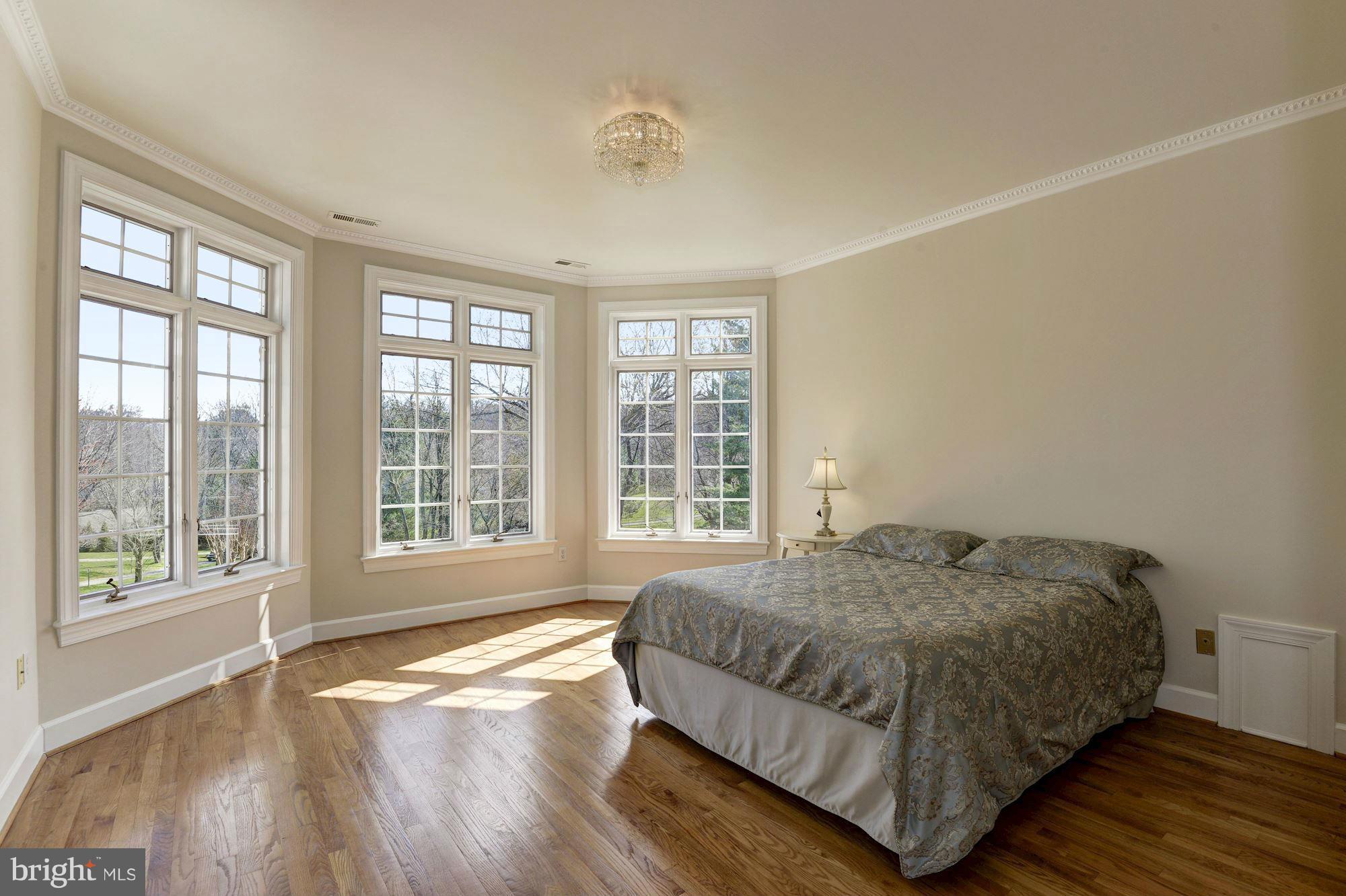 11112 Potomac View Drive Potomac, MD 20854 - Photo 22 of 30 a bedroom with a bed and wooden floor