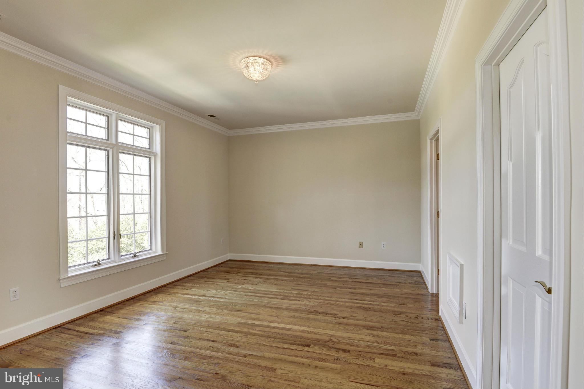11112 Potomac View Drive Potomac, MD 20854 - Photo 24 of 30 wooden floor in an empty room with a window
