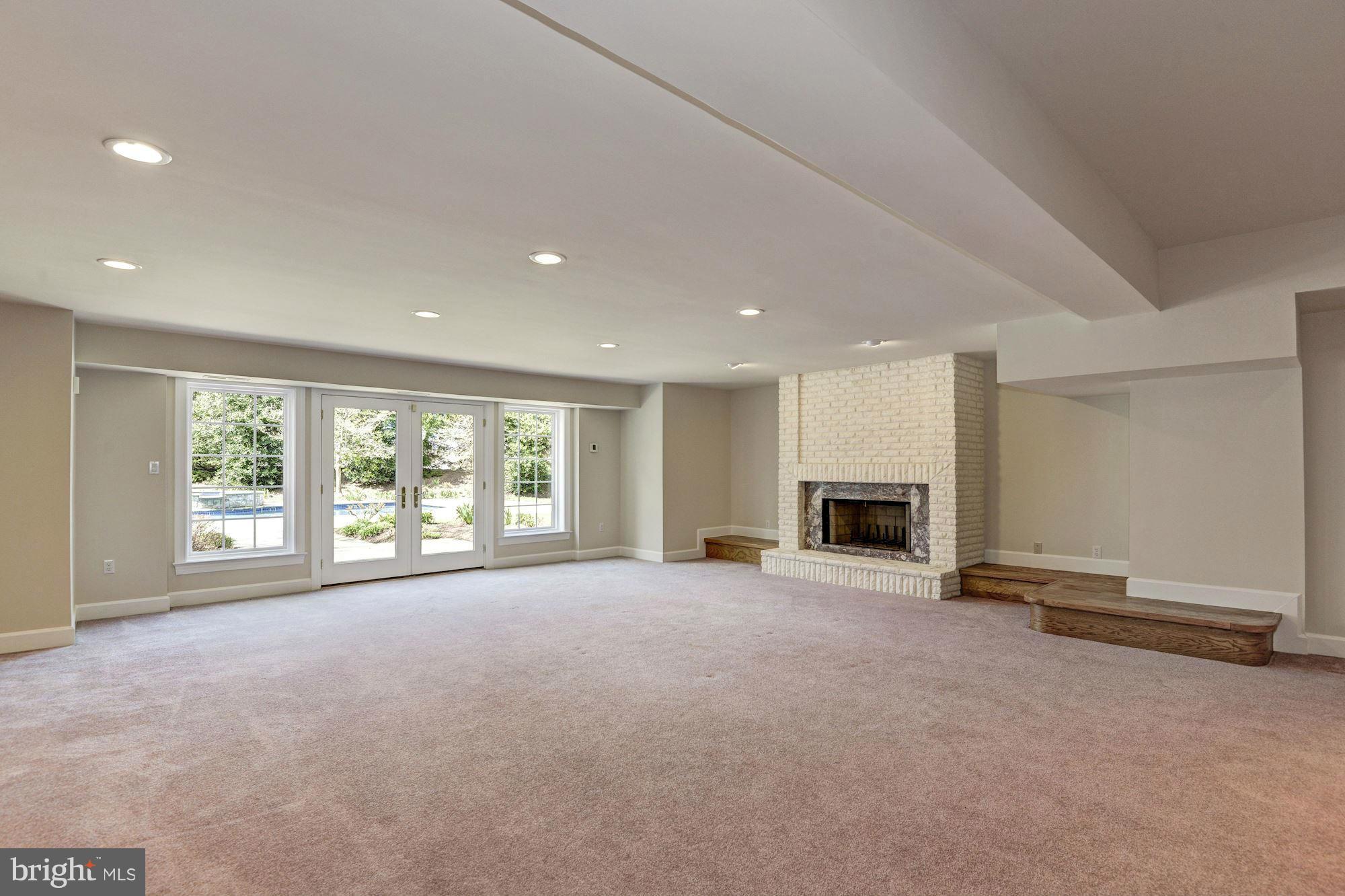 11112 Potomac View Drive Potomac, MD 20854 - Photo 25 of 30 a view of an empty room with a fireplace and a large window